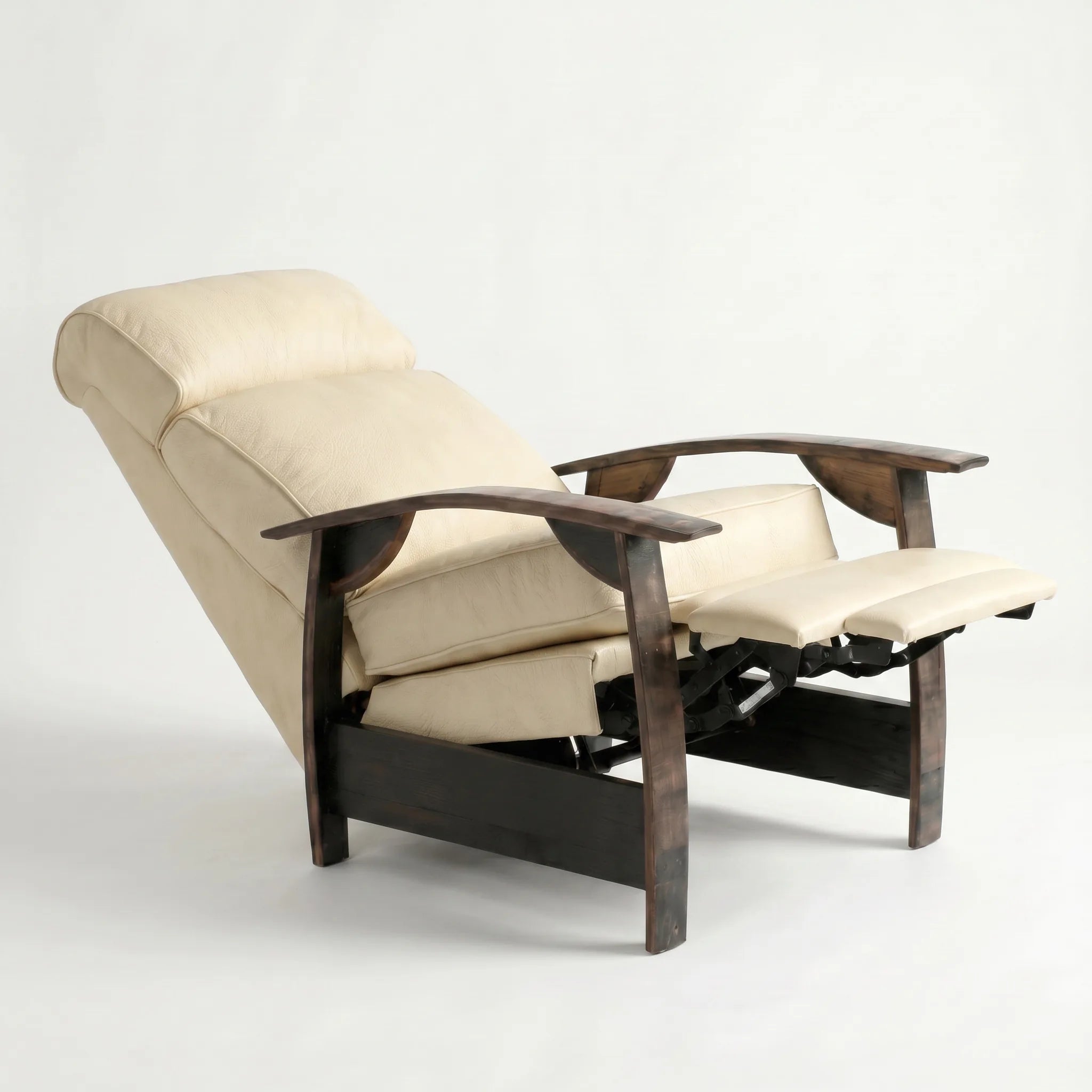 Cream ivory leather whiskey barrel recliner reclined with footrest extended and oak whiskey-barrel stave armrests, on a white background