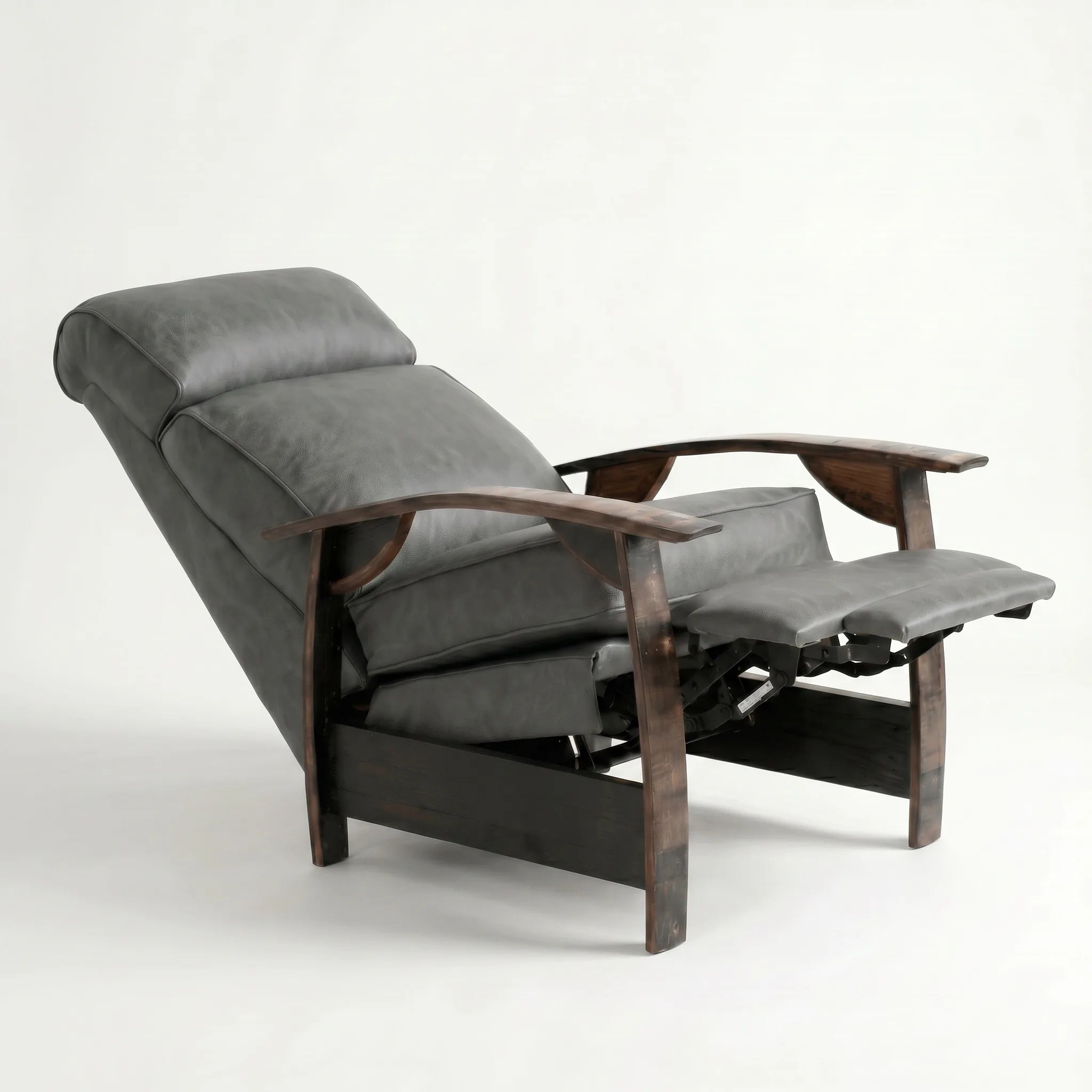 Slate gray leather whiskey barrel recliner reclined with footrest extended and oak whiskey-barrel stave armrests, on a white background