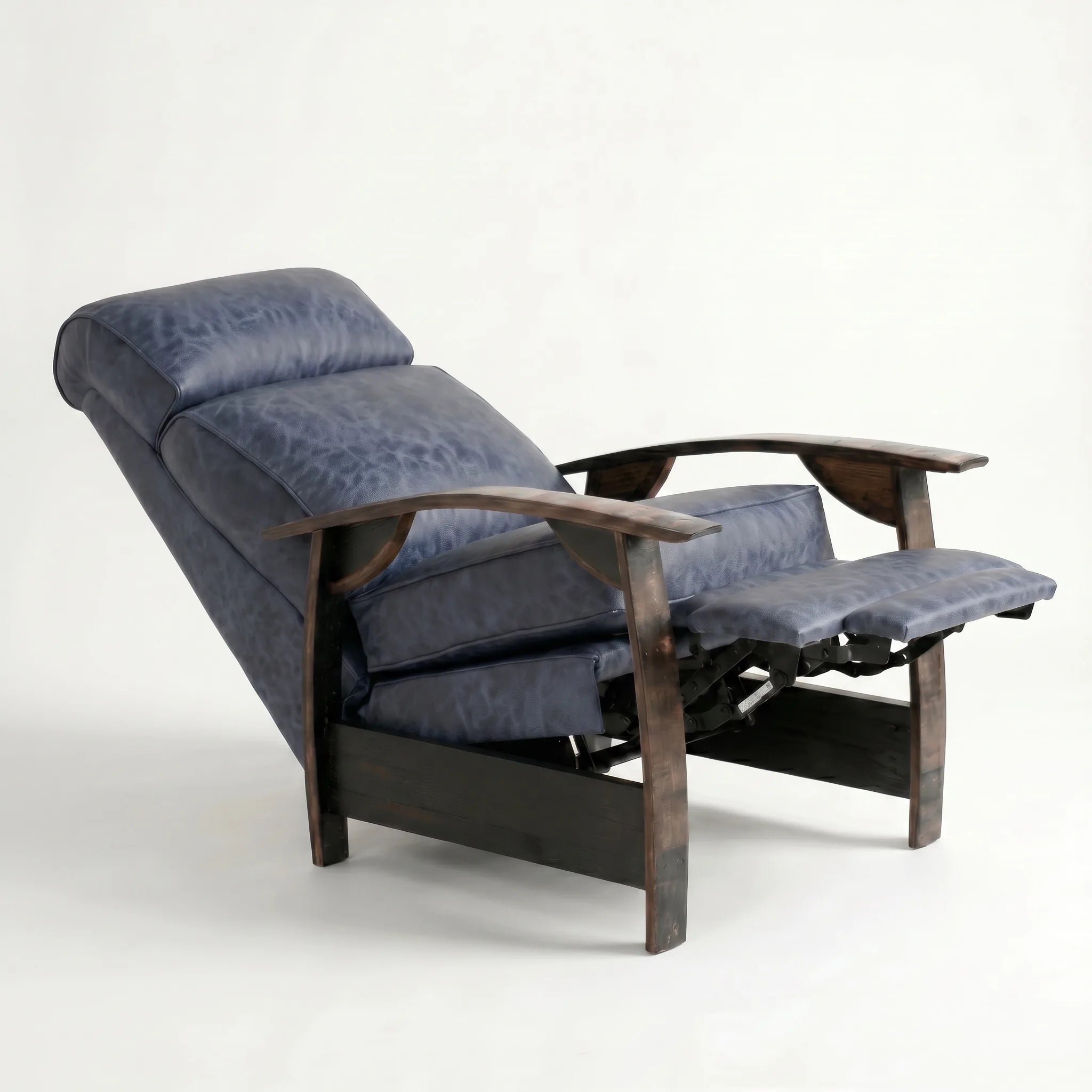 Denim blue leather whiskey barrel recliner reclined with footrest extended and oak whiskey-barrel stave armrests, on a white background