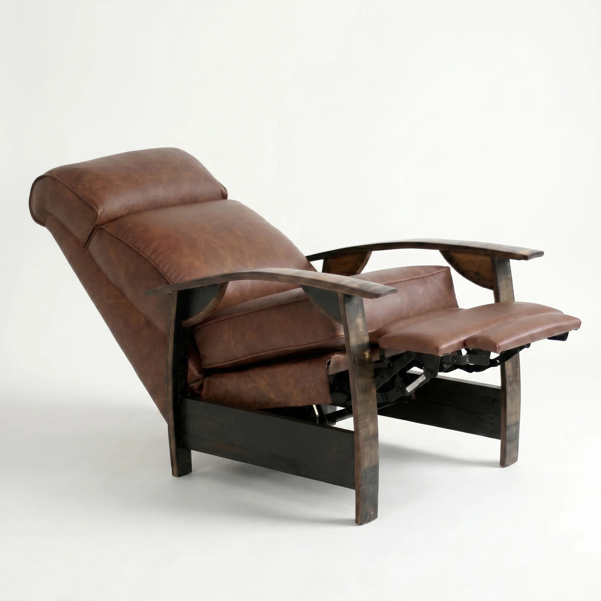 Whiskey-brown leather whiskey barrel recliner reclined with footrest extended and oak whiskey-barrel stave armrests, on a white background