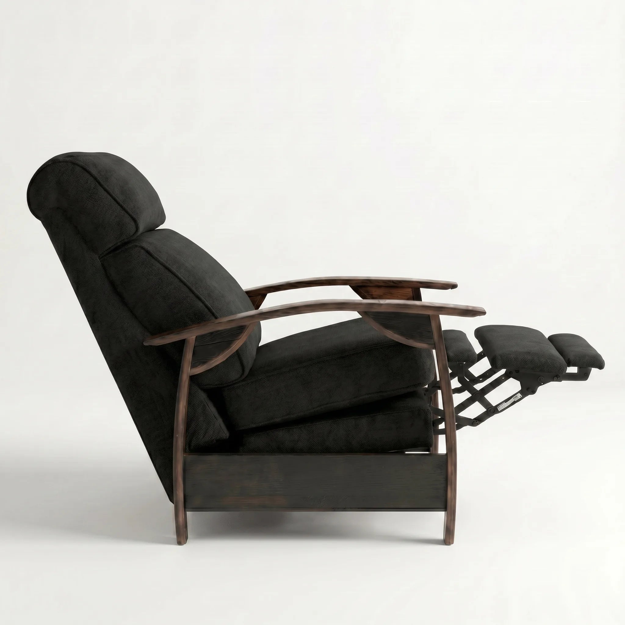 Side view of the black plush fabric whiskey barrel recliner partly reclined with footrest out, on a white background