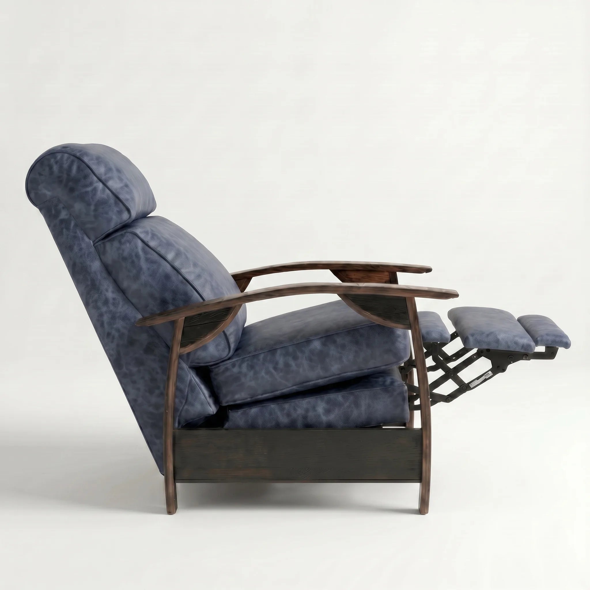 Side view of the denim blue leather whiskey barrel recliner partly reclined with footrest out, on a white background