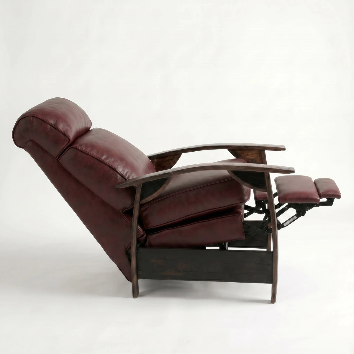 Side view of the oxblood leather whiskey barrel recliner fully reclined, on a white background