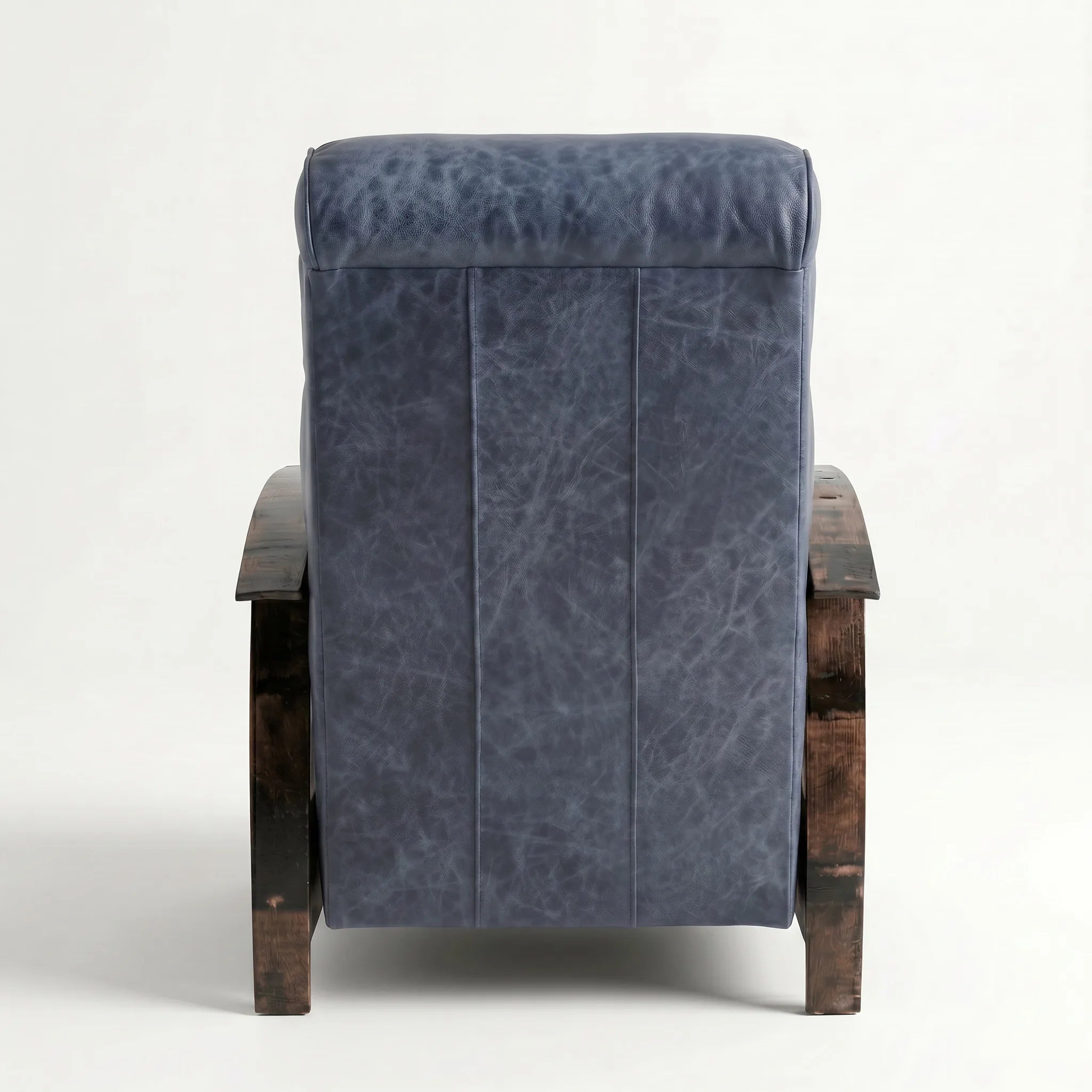 Rear view of the denim blue leather whiskey barrel recliner showing the back panel, on a white background