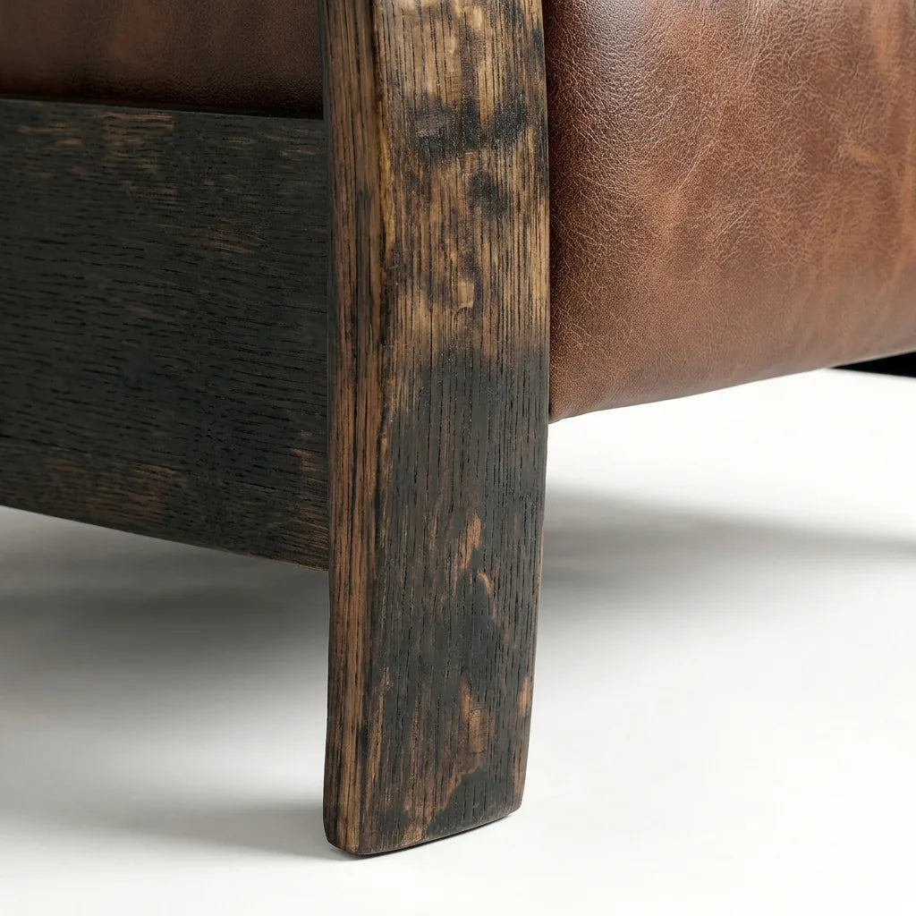 Close-up of the Big & Tall whiskey barrel recliner's oak whiskey-barrel stave leg in whiskey-brown leather, on a white background
