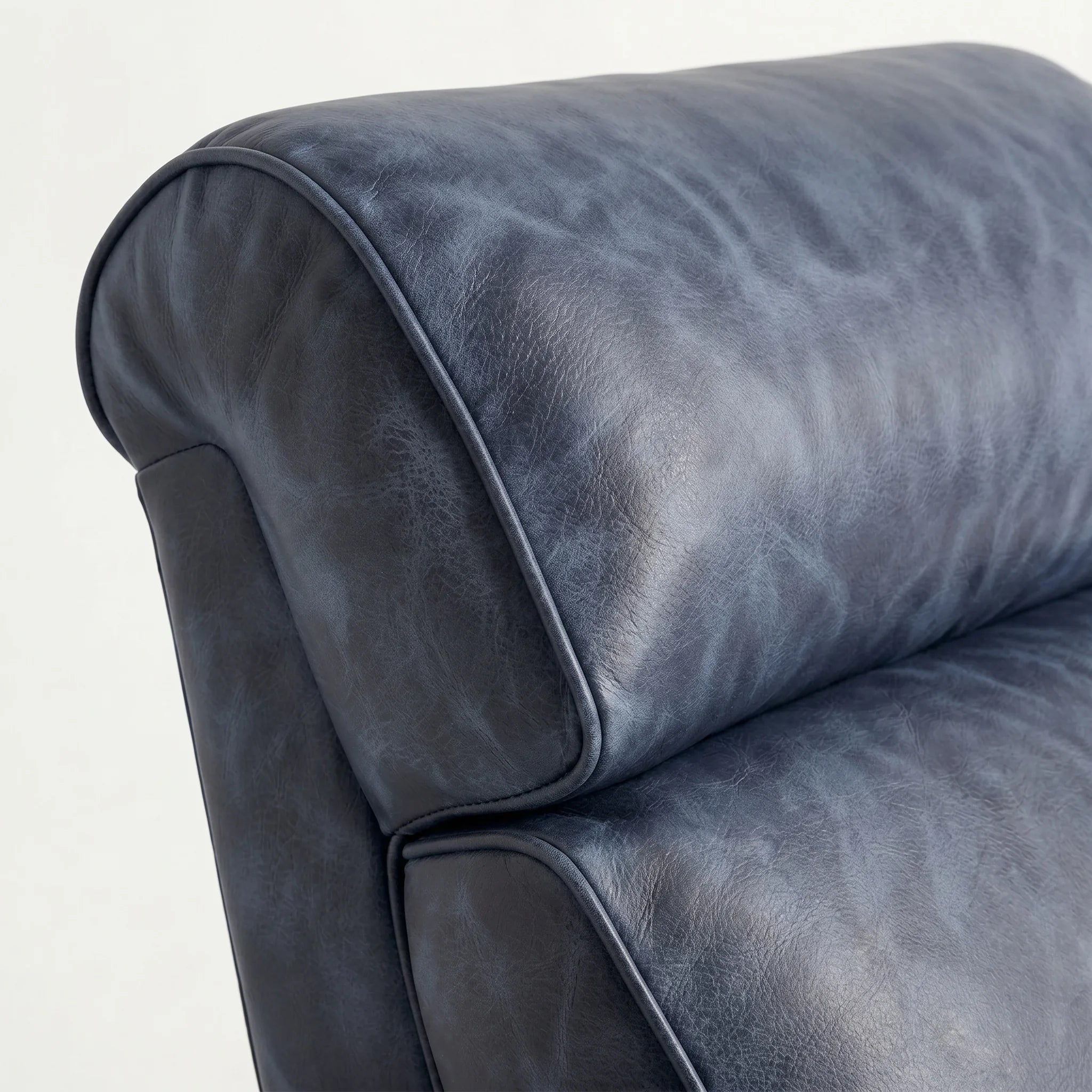 Close-up of the Big & Tall denim blue leather whiskey barrel recliner headrest and cushion, on a white background