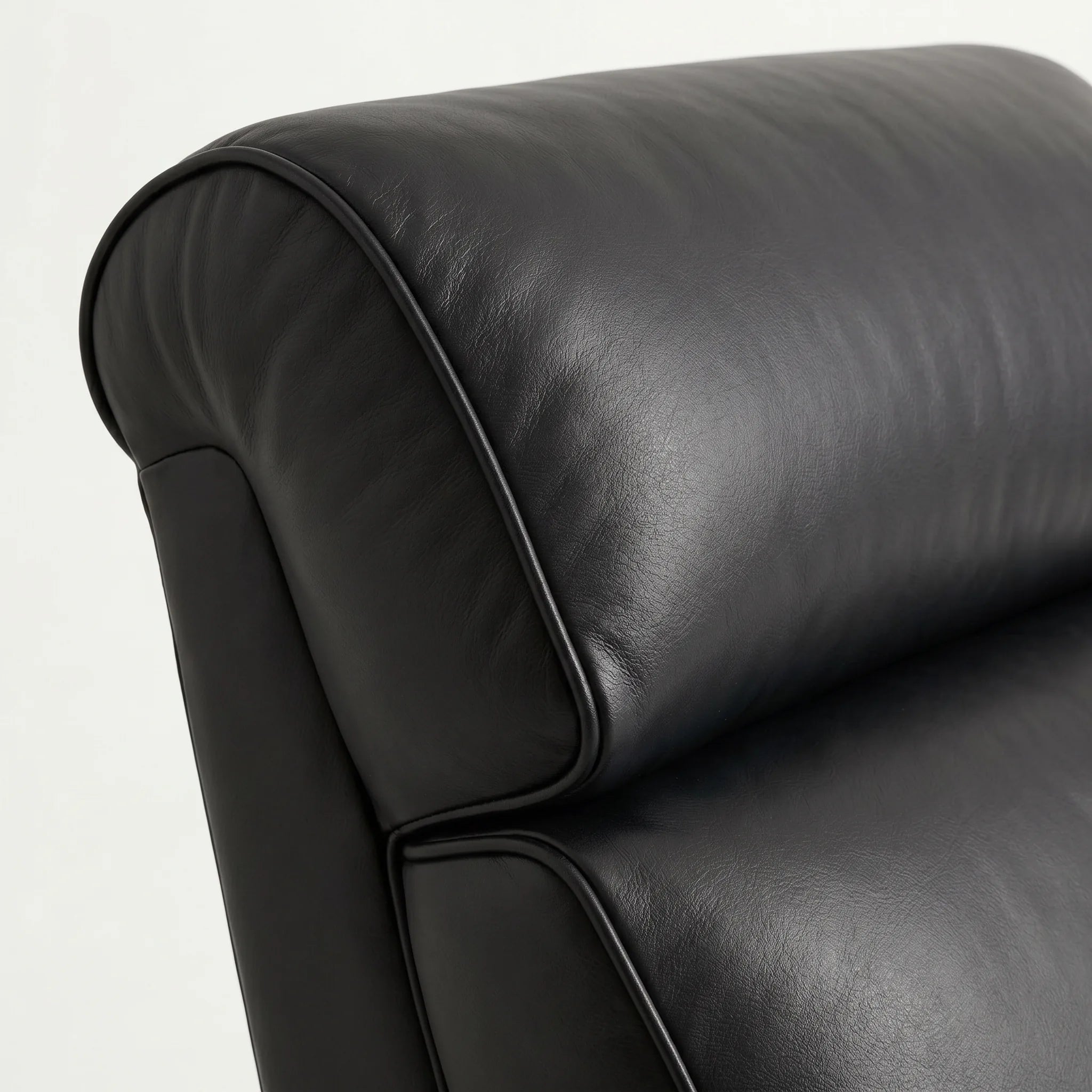 Close-up of the Big & Tall black leather whiskey barrel recliner headrest and cushion, on a white background
