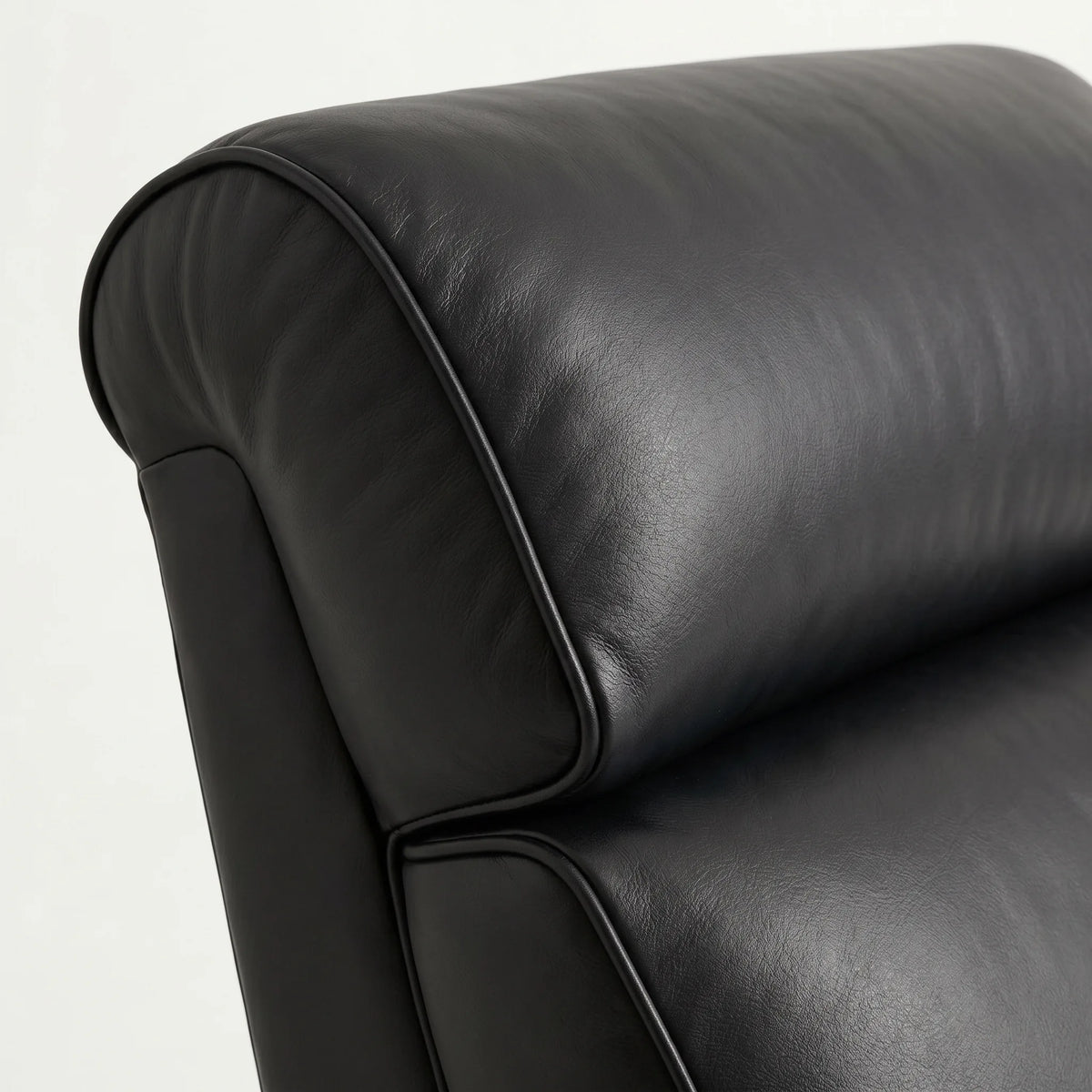 Close-up of the black leather whiskey barrel recliner headrest and cushion, on a white background