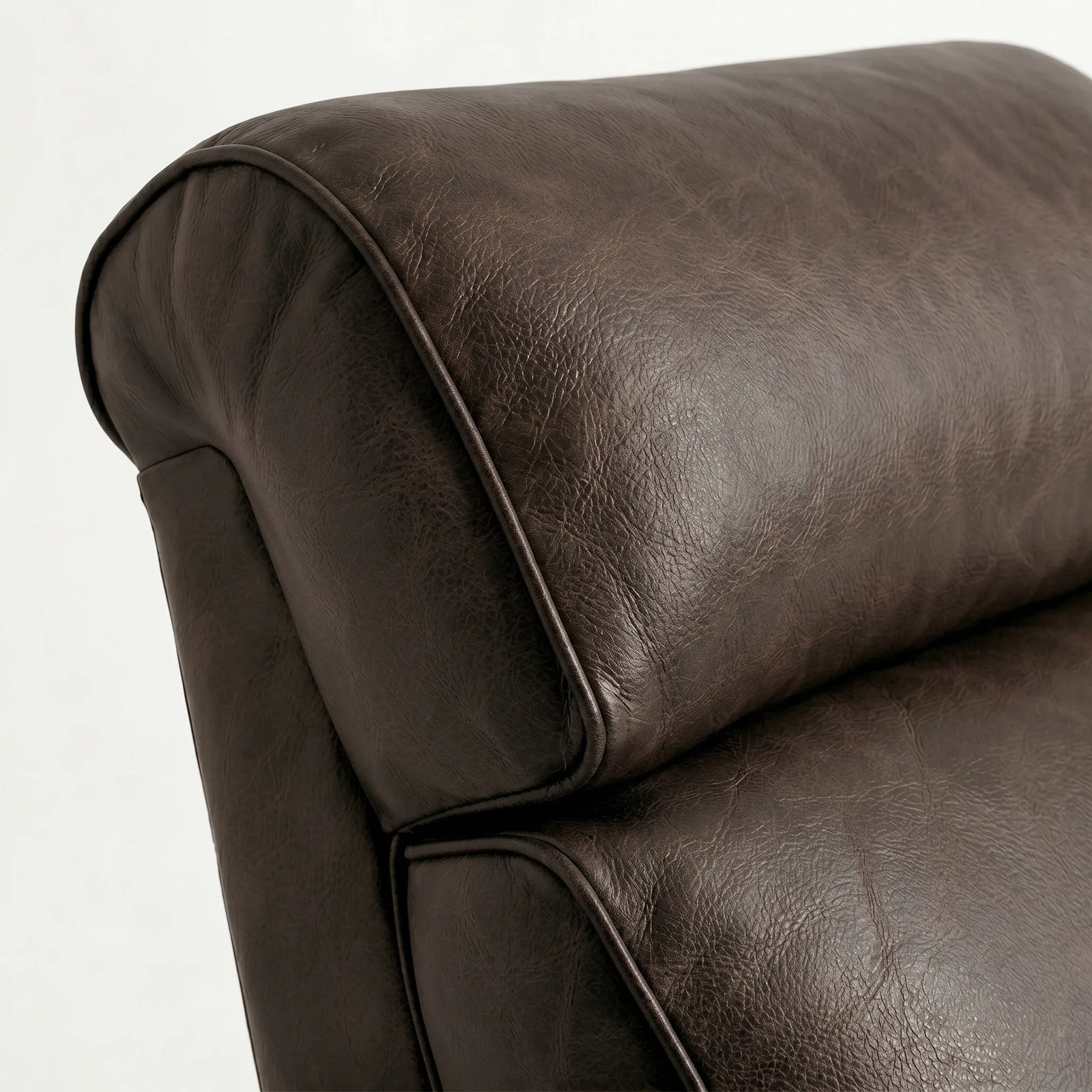 Close-up of the cognac brown leather whiskey barrel recliner headrest and cushion, on a white background