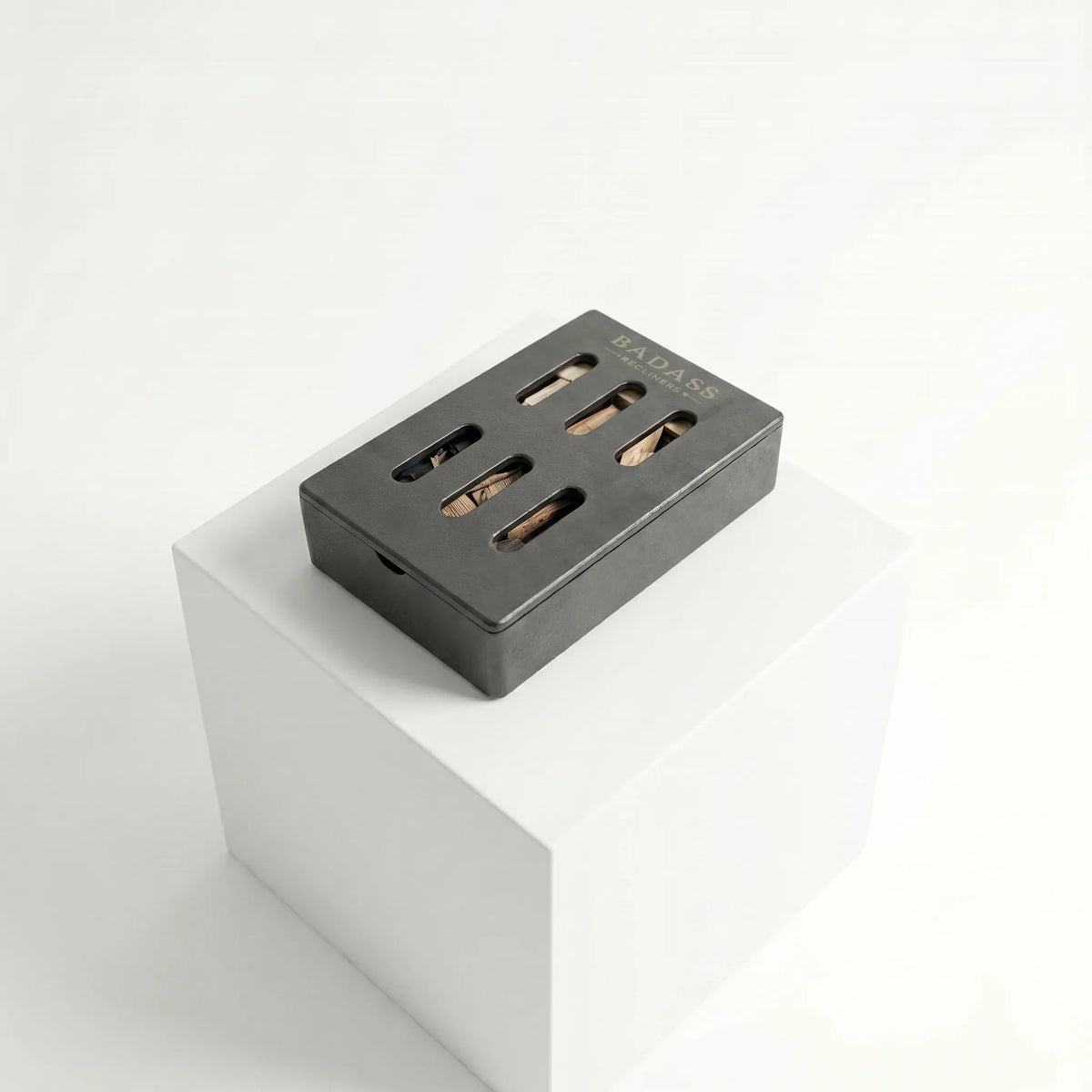 Black smoker box on a white pedestal with a white background