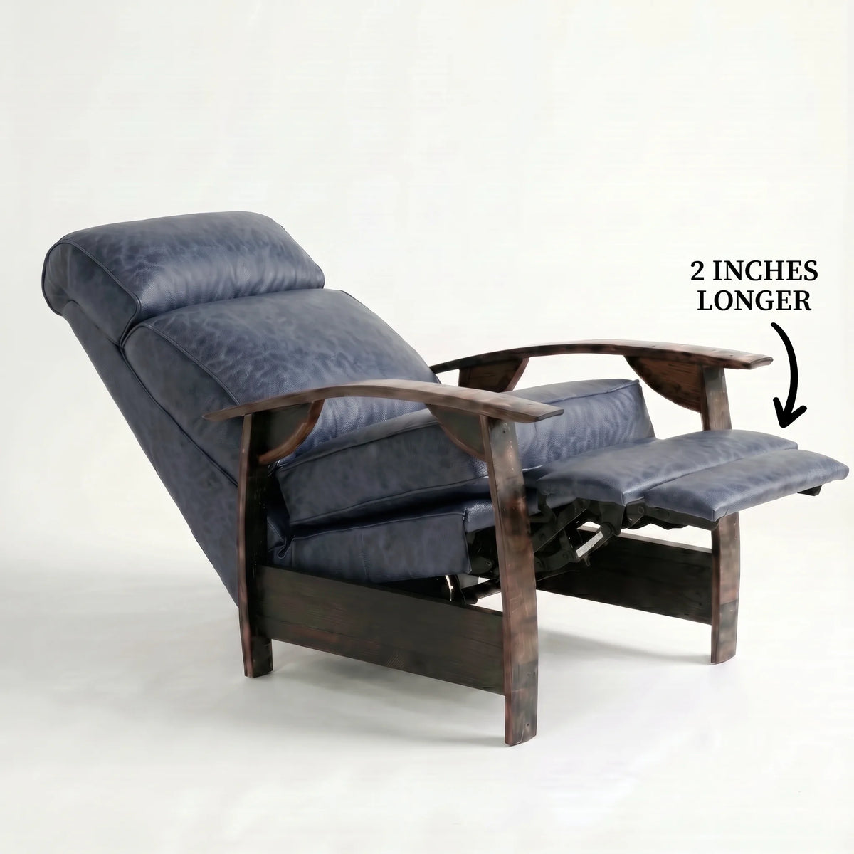 Extra Tall denim blue leather whiskey barrel recliner reclined with the 2-inch-longer footrest extended and oak whiskey-barrel stave armrests, on a white background