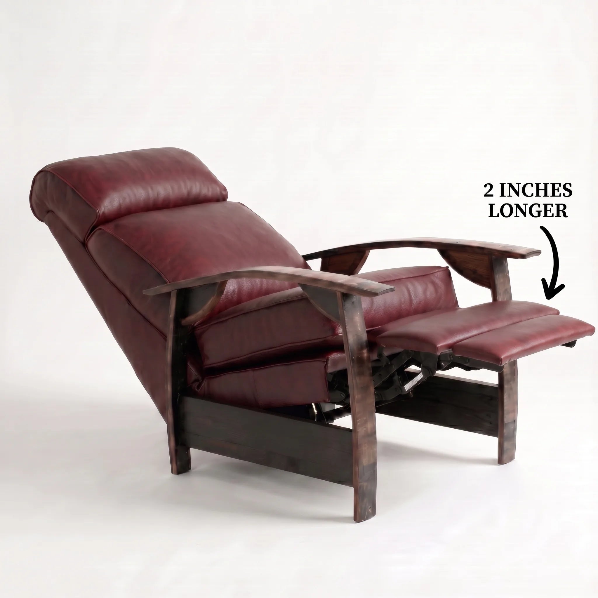 Big & Tall oxblood leather whiskey barrel recliner reclined with the 2-inch-longer footrest extended and oak whiskey-barrel stave armrests, on a white background