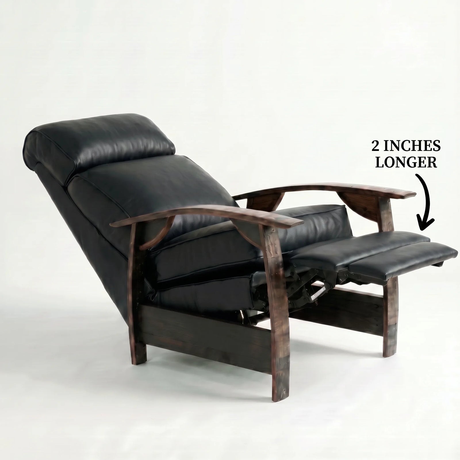 Big & Tall black leather whiskey barrel recliner reclined with the 2-inch-longer footrest extended and oak whiskey-barrel stave armrests, on a white background