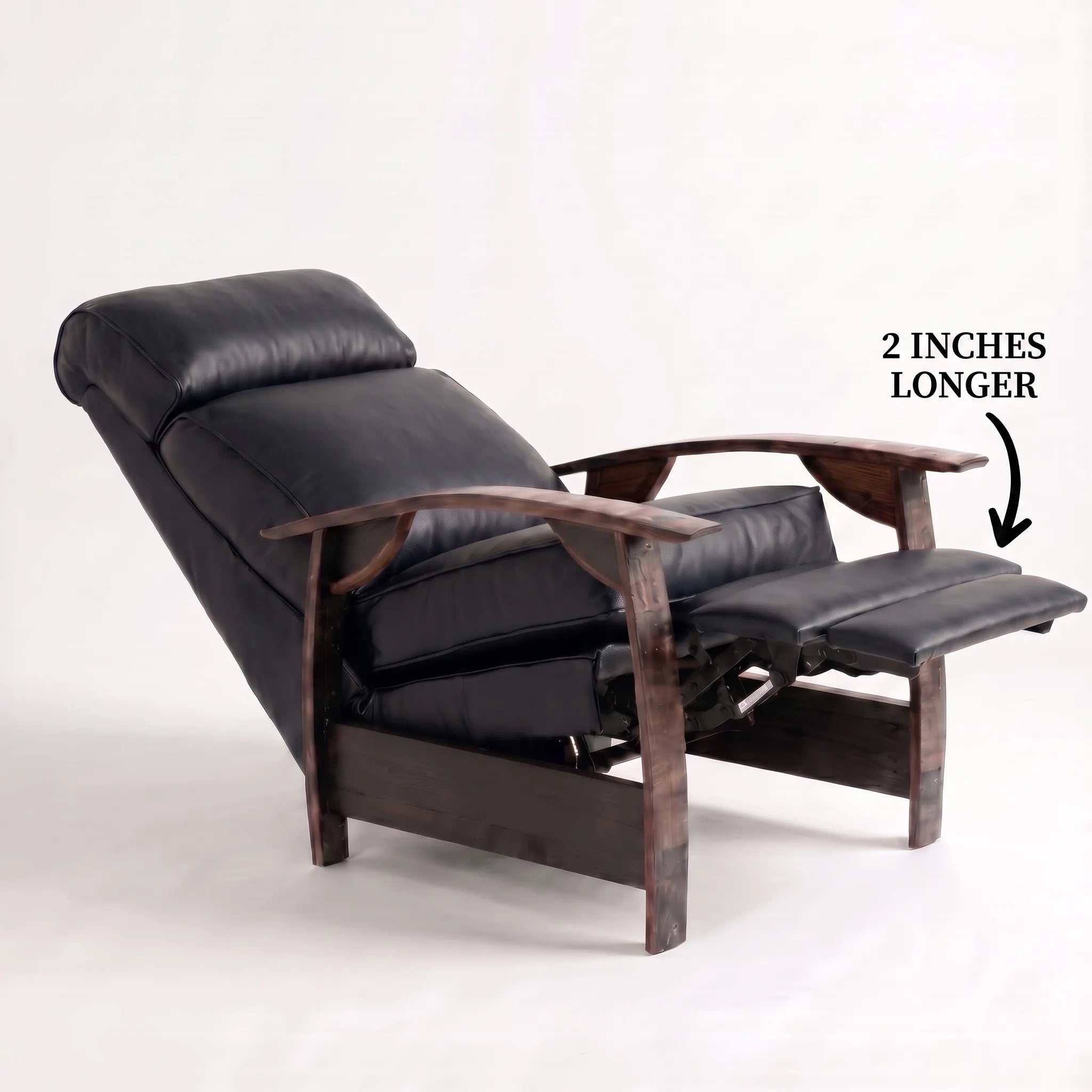 Big & Tall black leather whiskey barrel recliner reclined with the 2-inch-longer footrest extended and oak whiskey-barrel stave armrests, on a white background