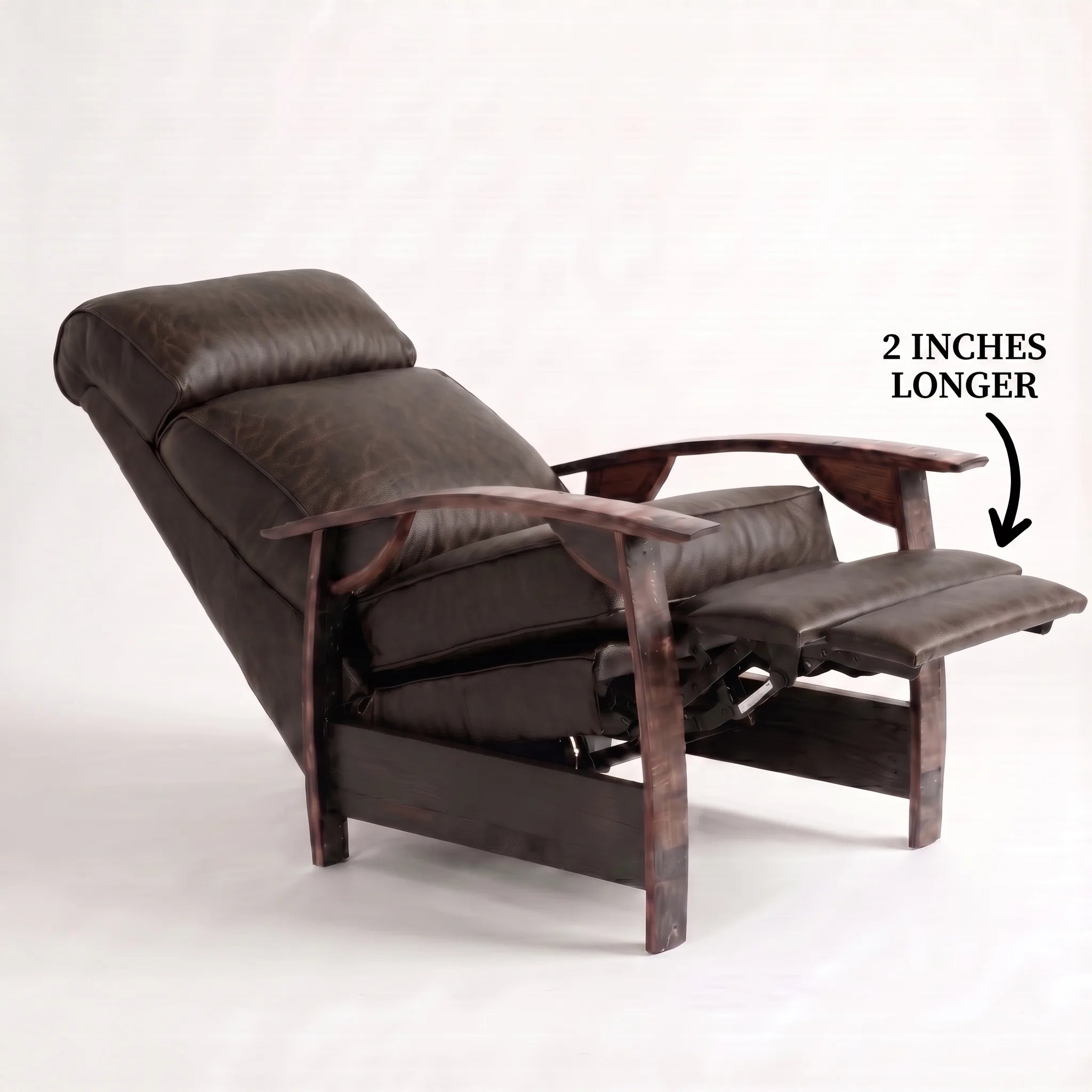Big & Tall cognac brown leather whiskey barrel recliner reclined with the 2-inch-longer footrest extended and oak whiskey-barrel stave armrests, on a white background