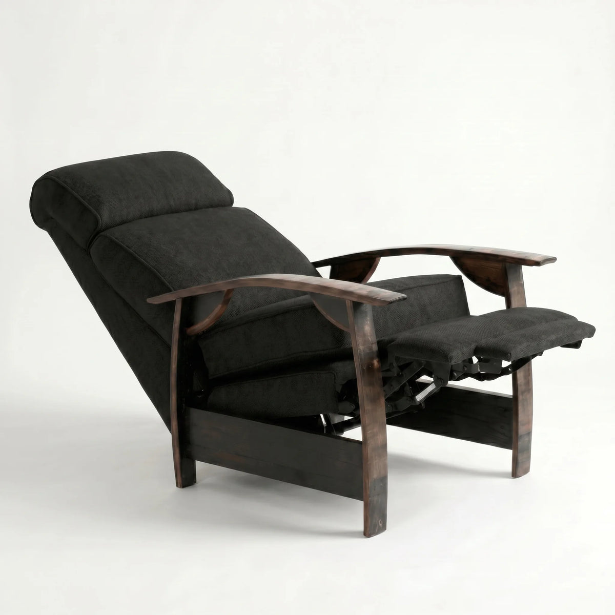 Black plush fabric whiskey barrel recliner reclined with footrest extended and oak whiskey-barrel stave armrests, on a white background