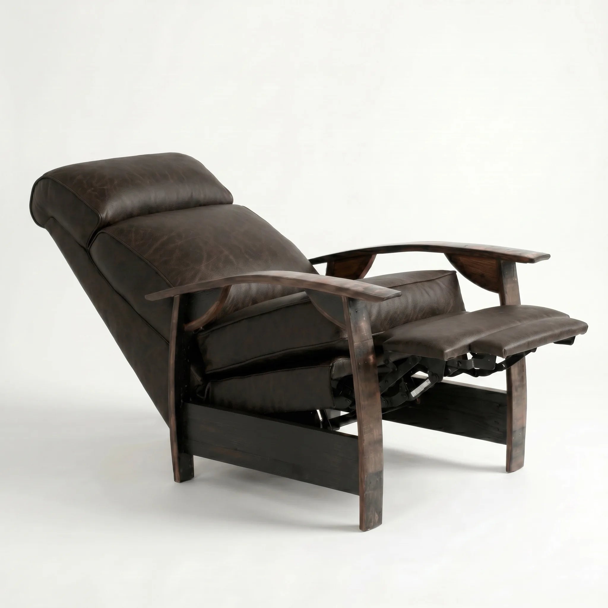 Cognac brown leather whiskey barrel recliner reclined with footrest extended and oak whiskey-barrel stave armrests, on a white background