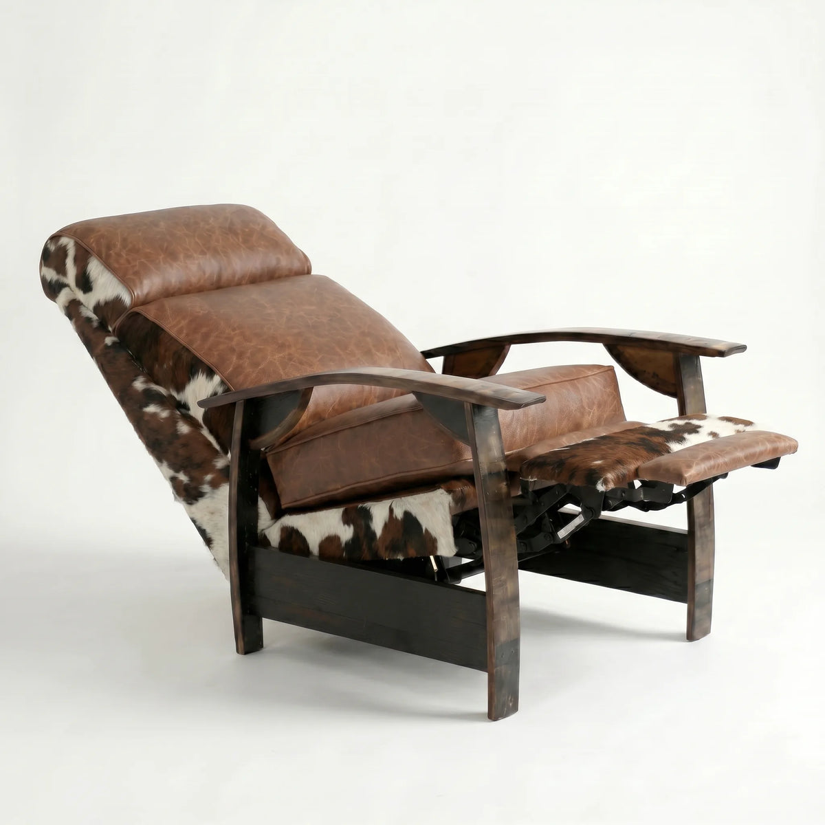 Tri-color cowhide whiskey barrel recliner reclined with footrest extended and oak whiskey-barrel stave armrests, on a white background