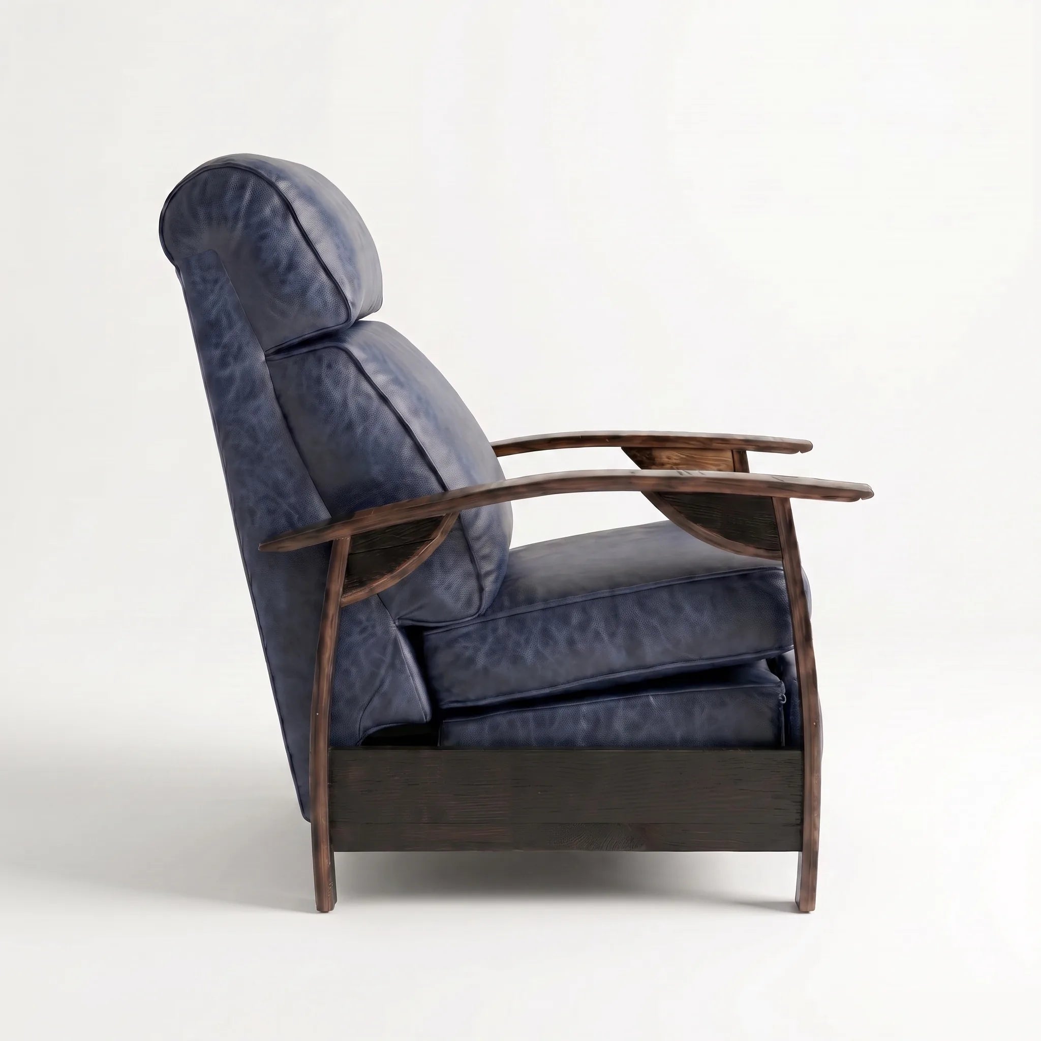 Side profile of the Big & Tall denim blue leather whiskey barrel recliner, upright and closed, on a white background