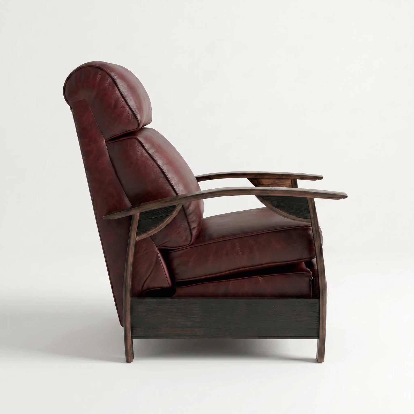 Side profile of the oxblood leather whiskey barrel recliner, upright and closed, on a white background
