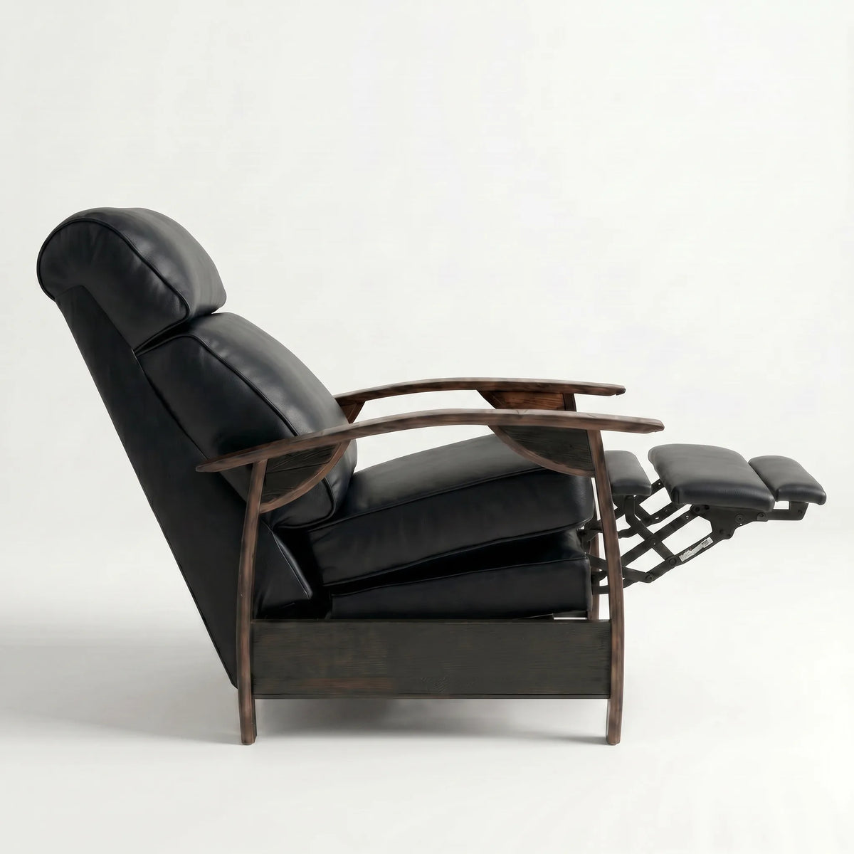 Side view of the black leather whiskey barrel recliner partly reclined with footrest out, on a white background