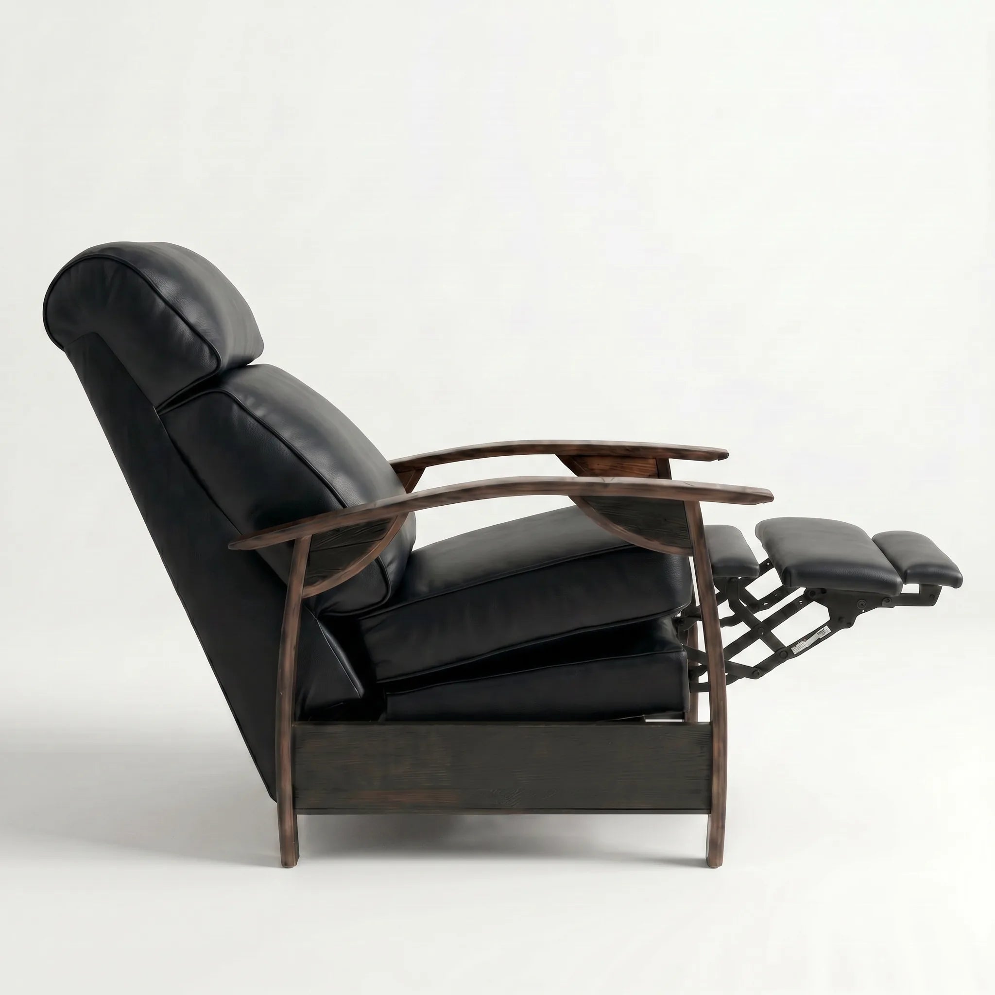 Side view of the black leather whiskey barrel recliner partly reclined with footrest out, on a white background