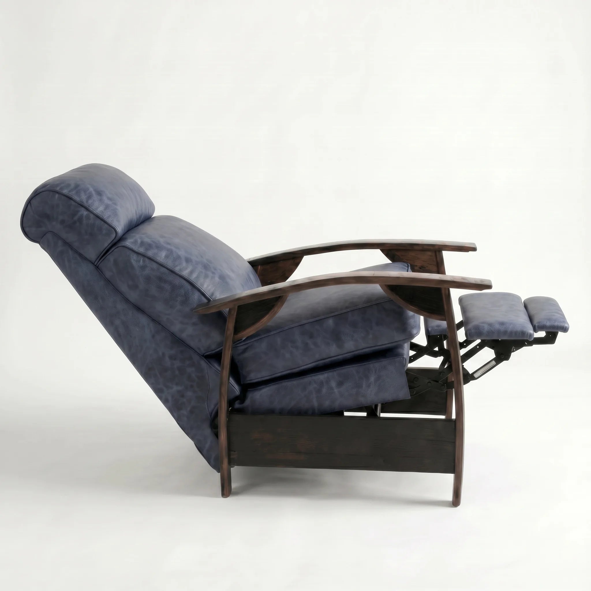 Side view of the denim blue leather whiskey barrel recliner fully reclined, on a white background