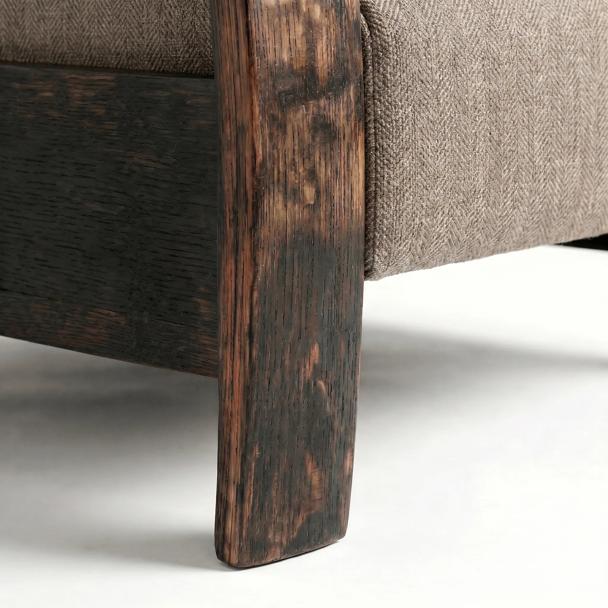 Close-up of the Big & Tall whiskey barrel recliner's oak whiskey-barrel stave leg in coffee brown plush fabric, on a white background
