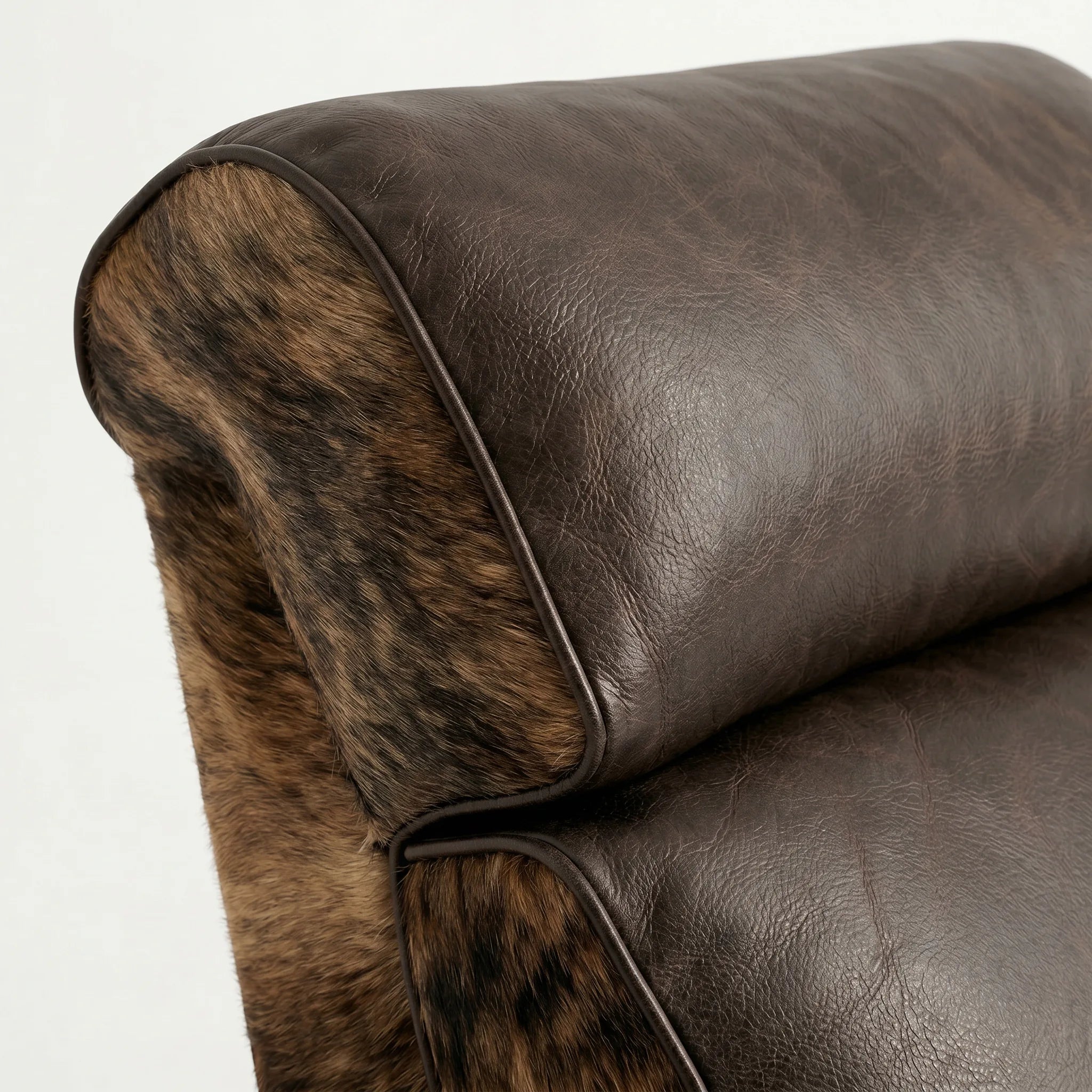 Close-up of the Big & Tall brindle cowhide whiskey barrel recliner headrest and cushion, on a white background
