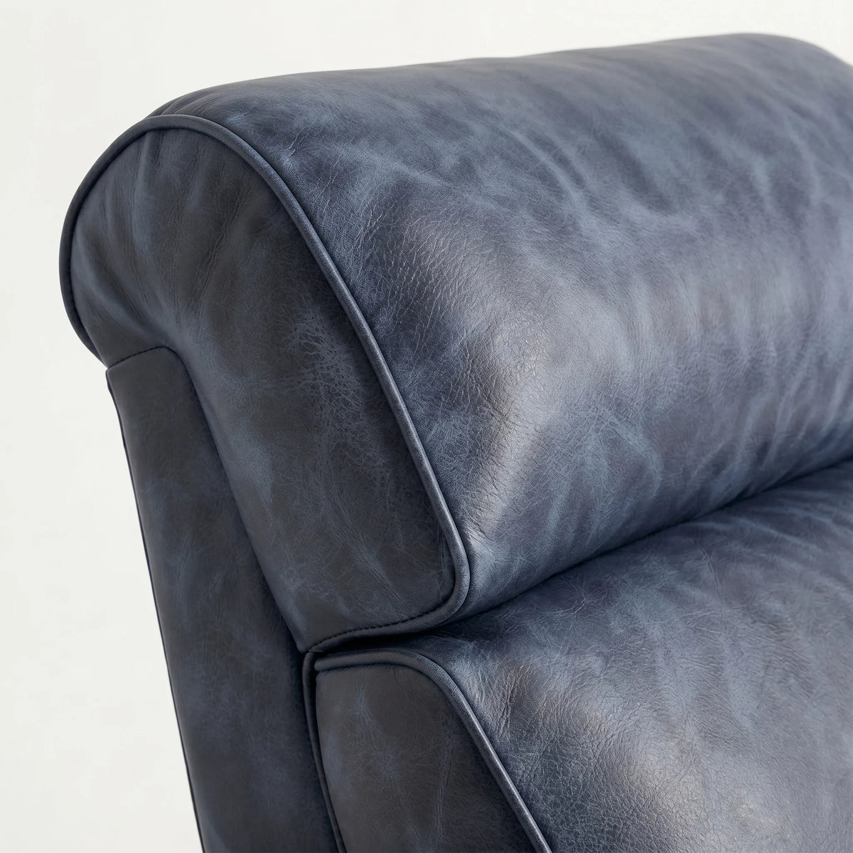 Close-up of the Extra Tall denim blue leather whiskey barrel recliner headrest and cushion, on a white background