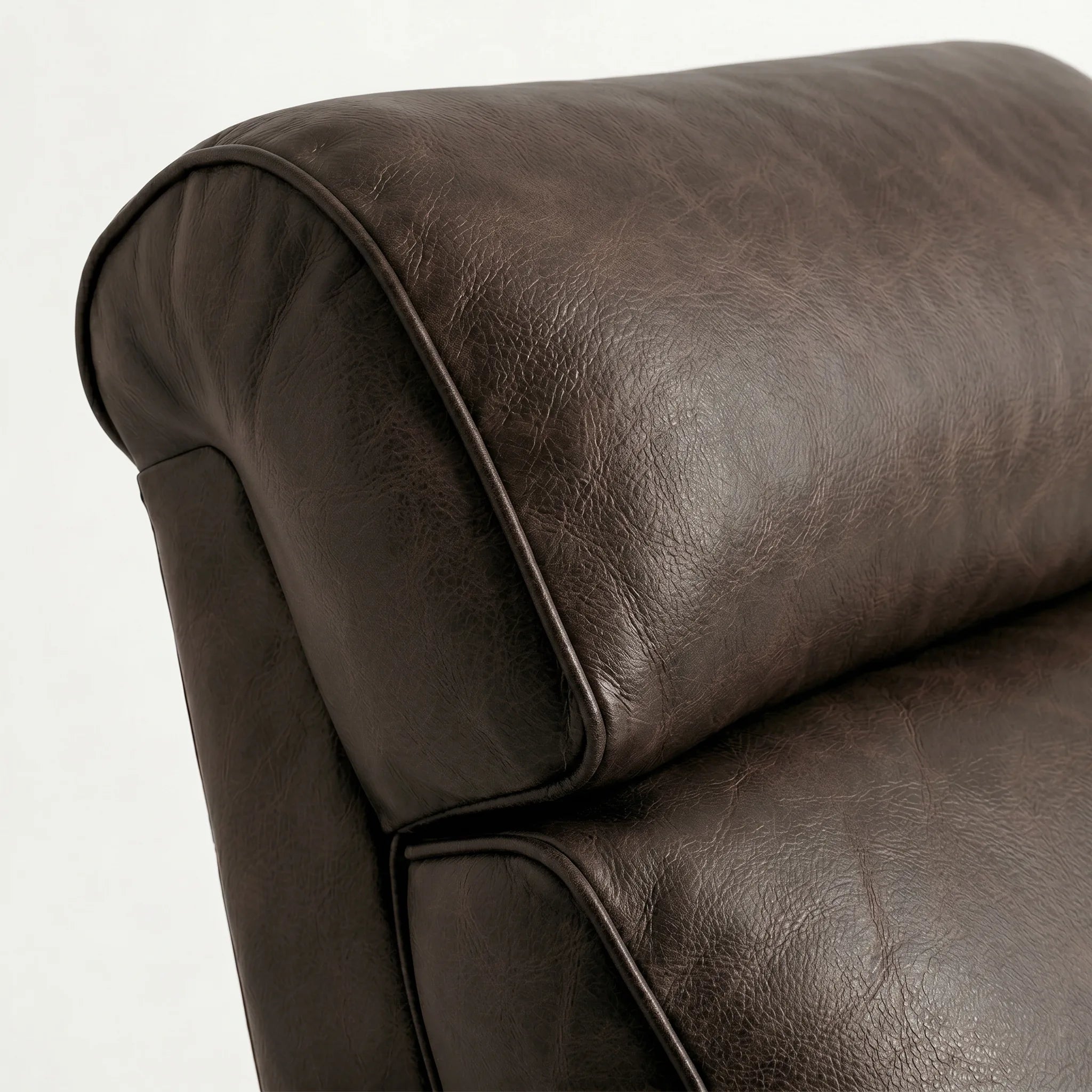 Close-up of the Big & Tall cognac brown leather whiskey barrel recliner headrest and cushion, on a white background