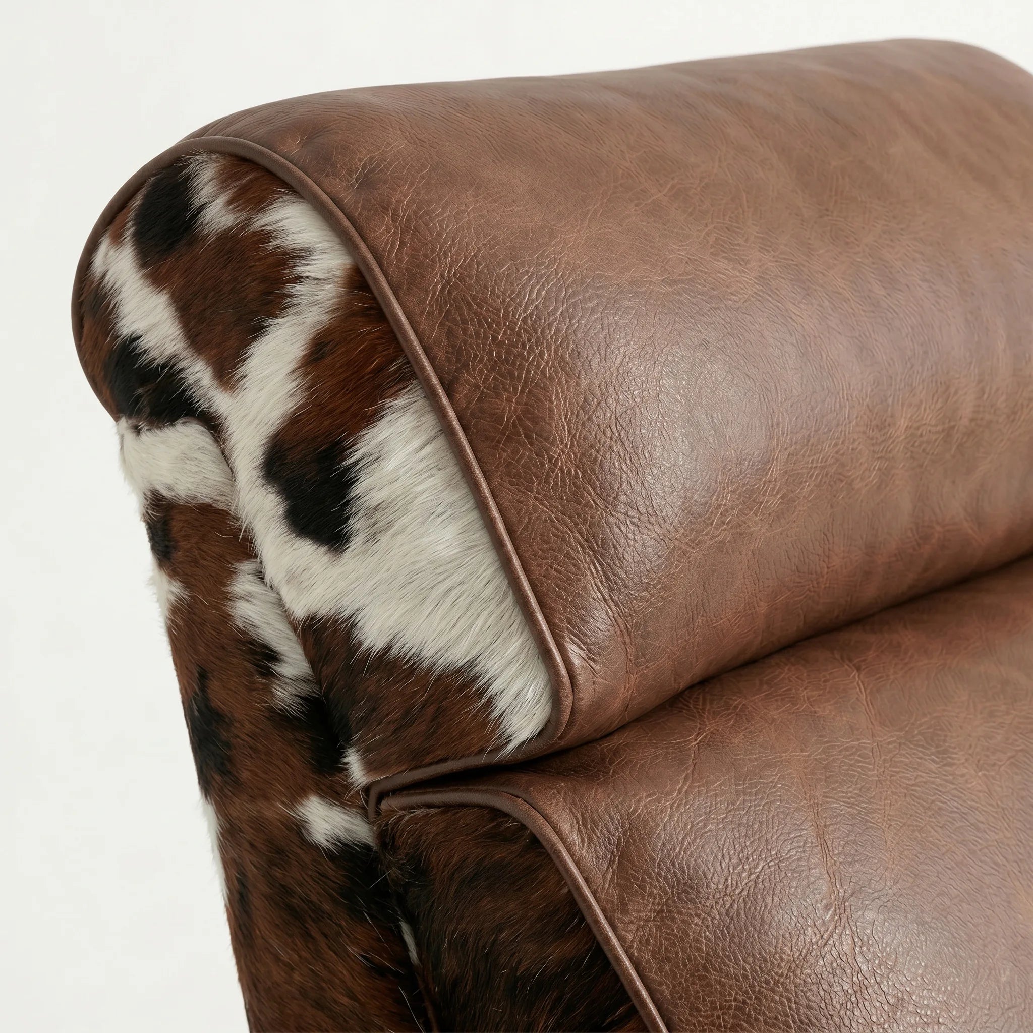 Close-up of the Big & Tall tri-color cowhide whiskey barrel recliner headrest and cushion, on a white background