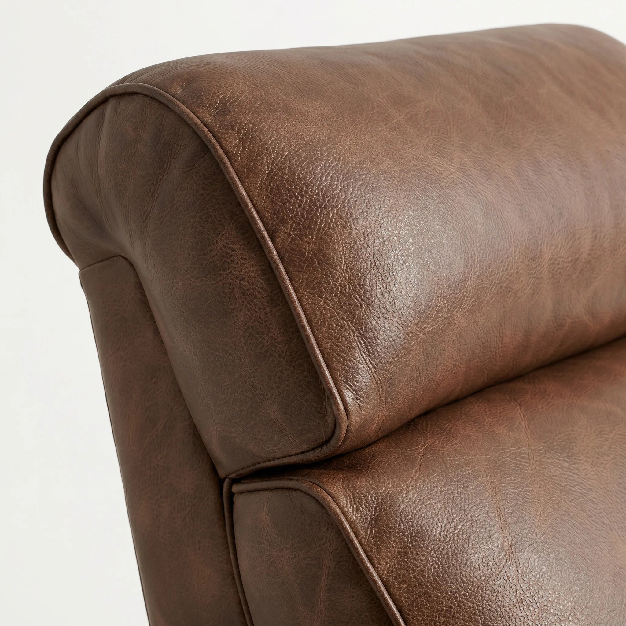 Close-up of the Big & Tall whiskey-brown leather whiskey barrel recliner headrest and cushion, on a white background