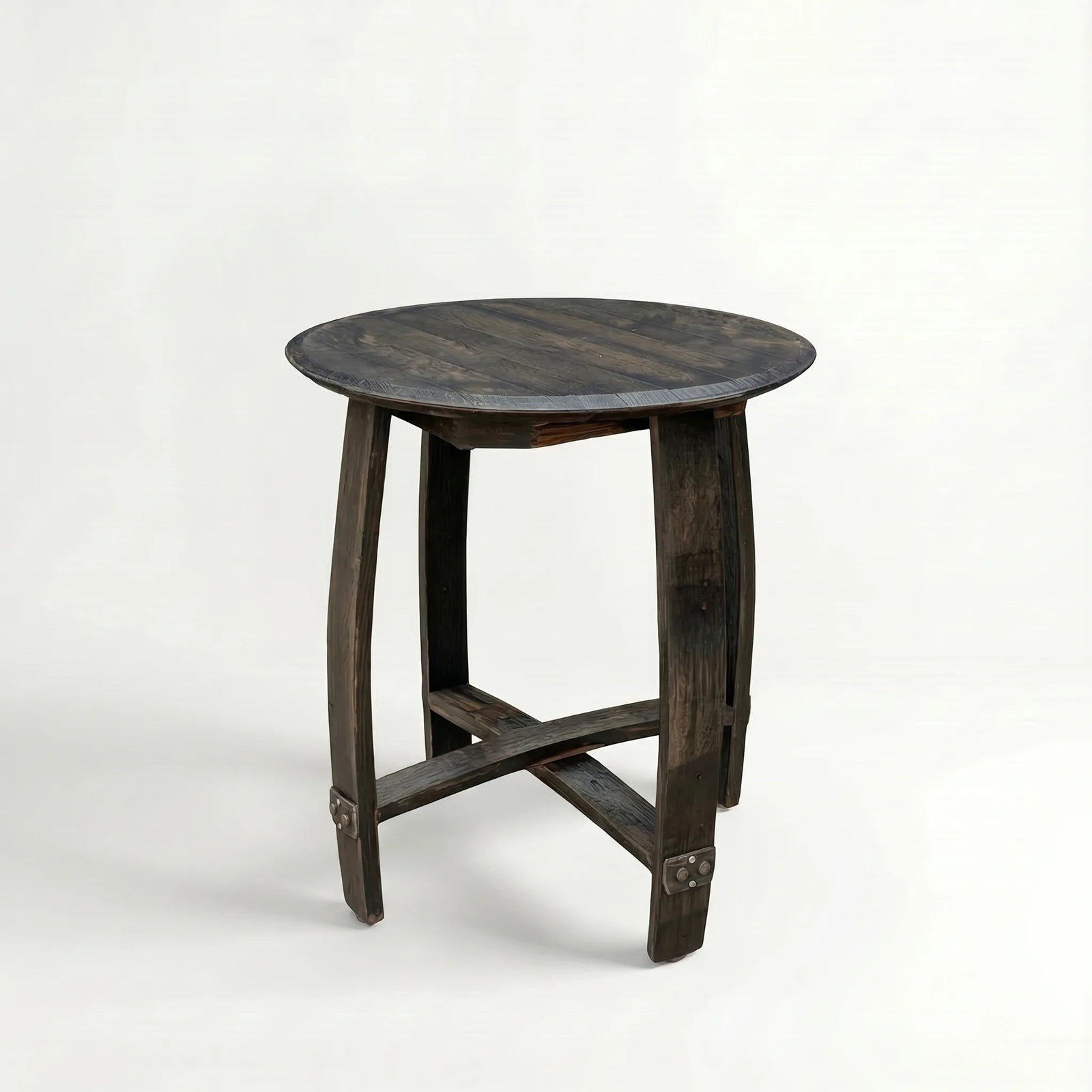 Round wooden side table made out of a whiskey barrel on a white background