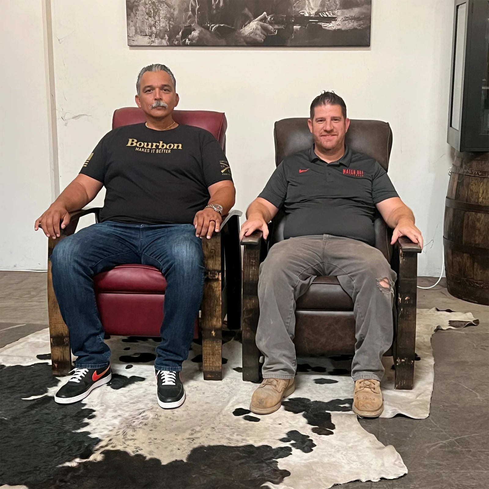 A 6'5" man and a 5'11" man seated side by side in the Big & Tall and the standard Whiskey Barrel Recliner, comparing the fit